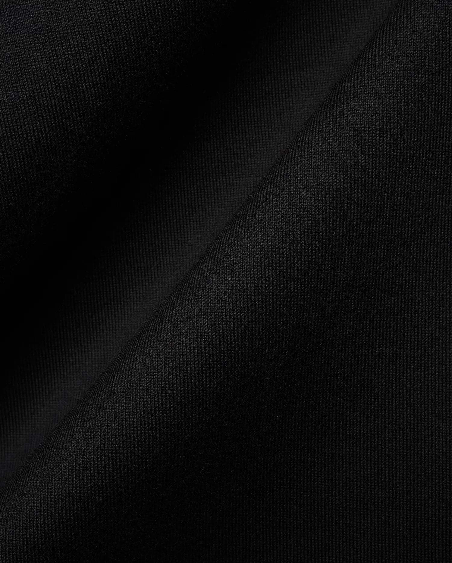 Black MENS OLEK RELAXED BACK GRAPHIC TEE, a premium Psycho Bunny streetwear piece, featuring soft, finely ribbed knit fabric with a subtle sheen, highlighting its luxurious feel and relaxed fit. (6)