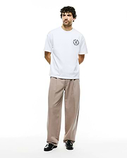 Mens Olek Relaxed Back Graphic Tee, a white relaxed-fit jersey t-shirt featuring a black circular Psycho Bunny skull logo with text on the left chest. (5)