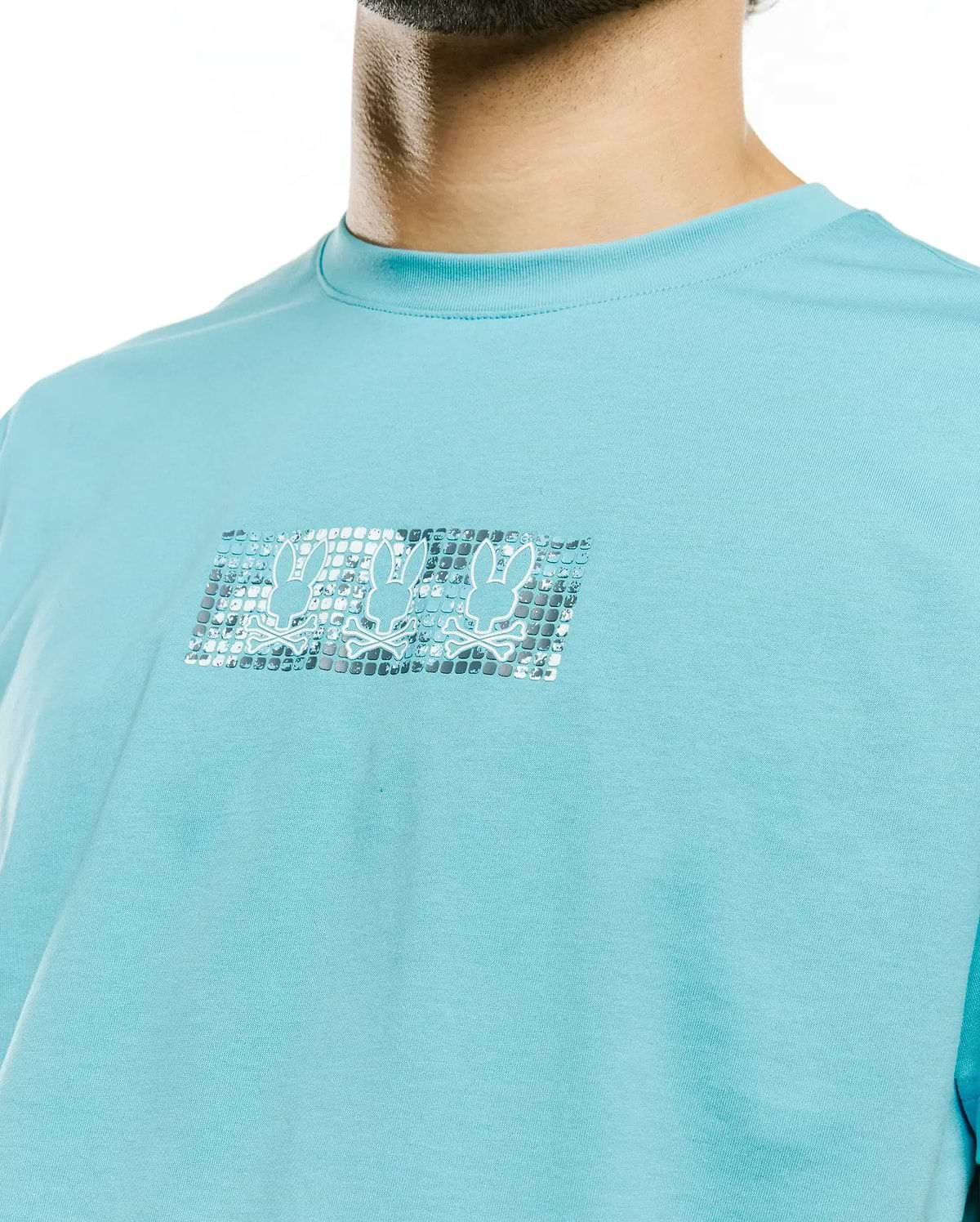 Men's Alfie Back Graphic Tee, aqua blue classic fit jersey knit with a chest graphic featuring three metallic silver Psycho Bunny skull logos on a textured rectangular background. (3)