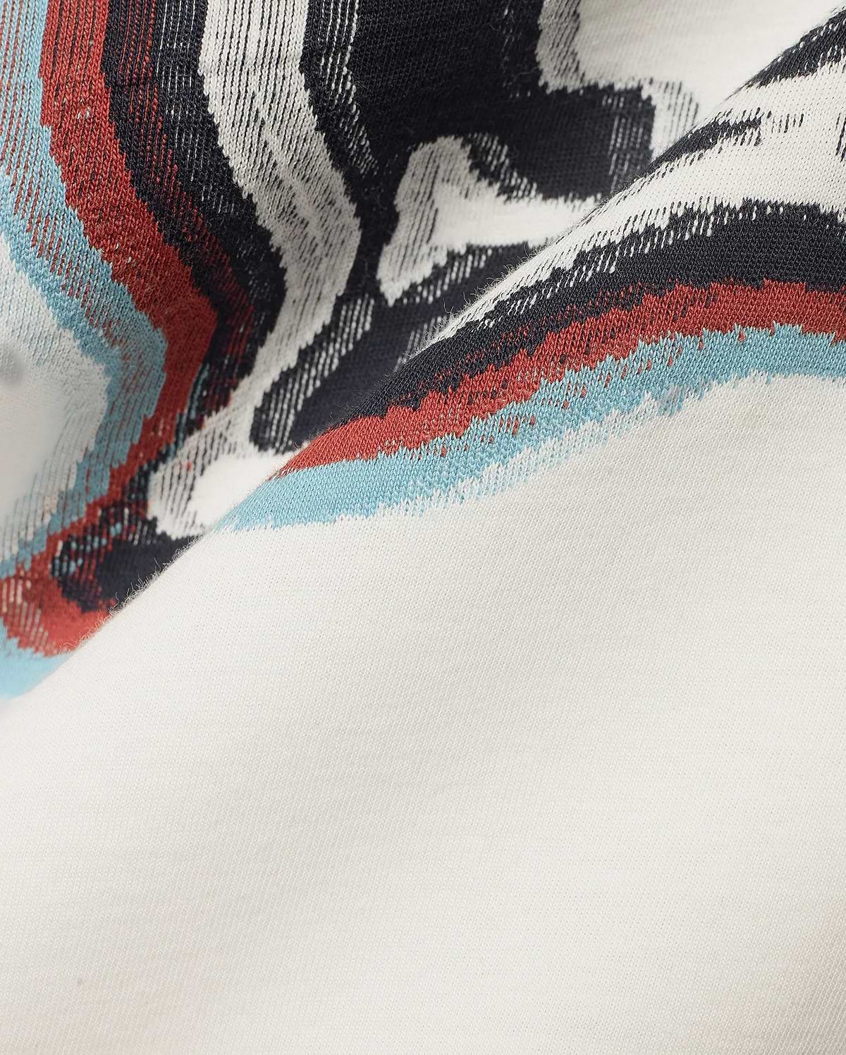 Men's Klaus Jacquard Tee featuring a cream jersey knit base with a bold jacquard pattern of black, white, red, and light blue wavy stripes. (6)