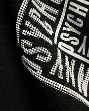 Men's Raj Wordmark Graphic Tee, a black jersey t-shirt featuring a prominent white graphic print with a unique textured dotted effect on parts of the Psycho Bunny wordmark. (6)