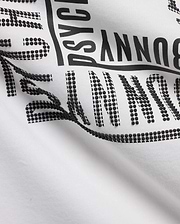 White Men's Raj Wordmark Graphic Tee in jersey knit, featuring a large black Psycho Bunny wordmark with a unique textured design where some letters are solid and others are raised black dots. (6)
