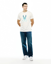 Men's Slade Bunny Graphic Tee, an ecru classic fit jersey t-shirt featuring a large chest graphic of the iconic Psycho Bunny skull logo in a blue gradient striped design, with a small woven tag on the hem. (5)