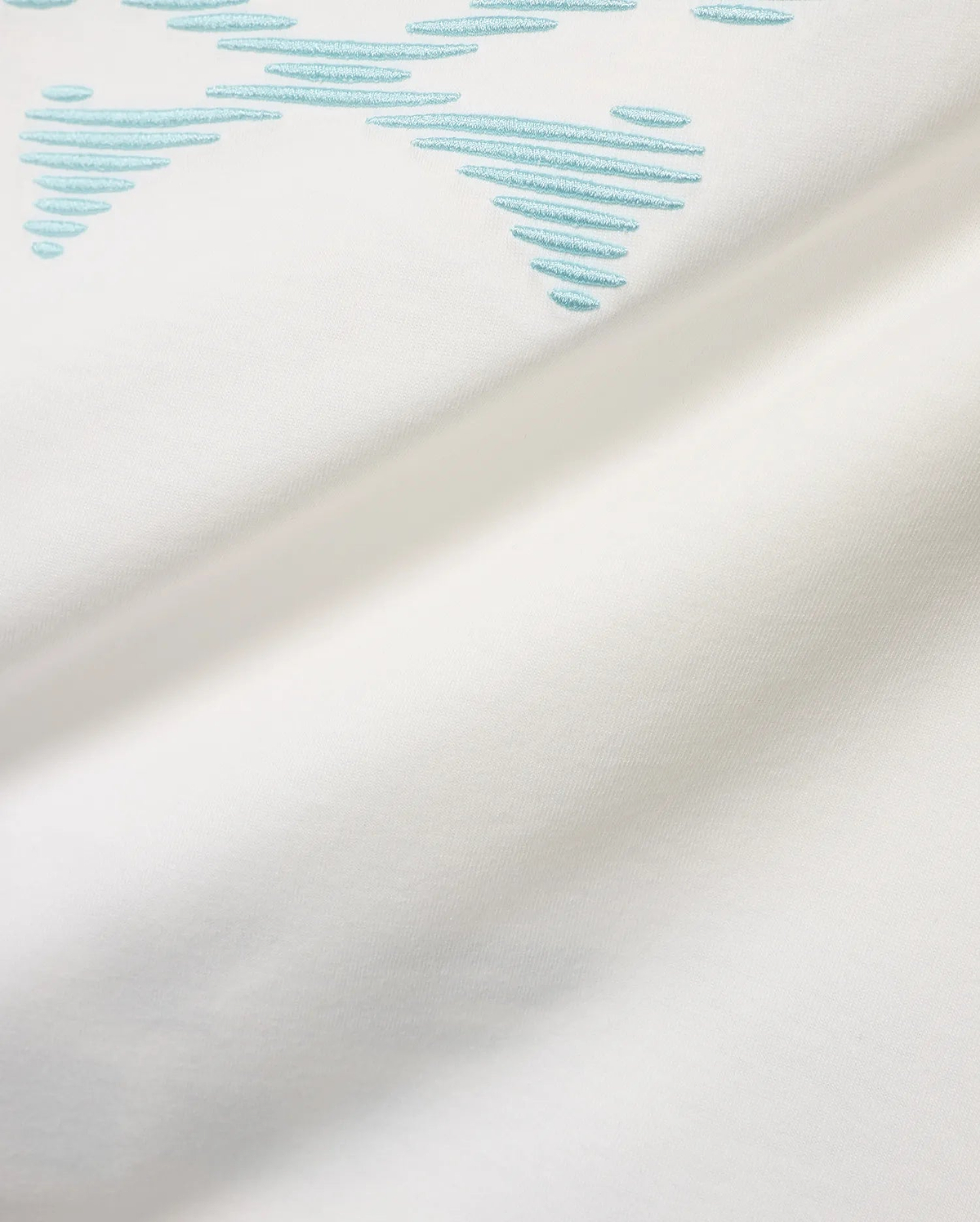 Men's Slade Bunny Graphic Tee, a white smooth jersey t-shirt featuring a prominent light blue embroidered stylized bunny skull graphic formed by horizontal lines. (6)