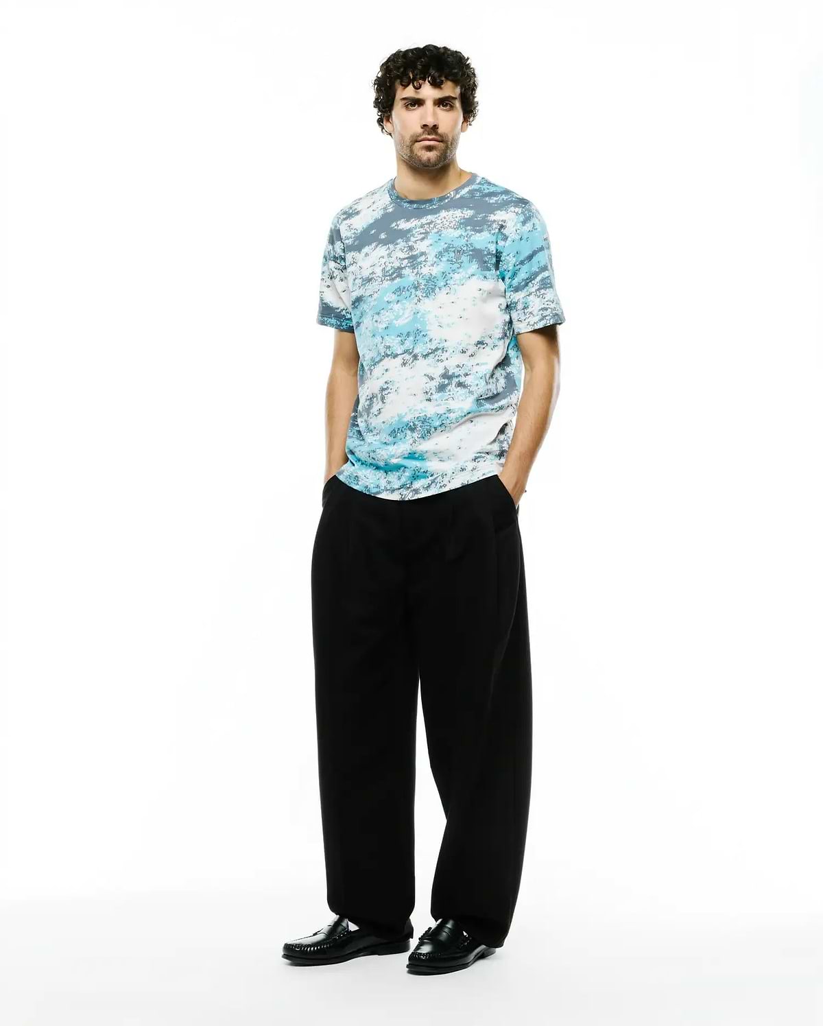 Psycho Bunny Men's Alfie All-Over Jacquard Tee, a premium relaxed fit t-shirt with a soft jersey texture and an abstract blue, white, and grey cloud-like pattern. (4)