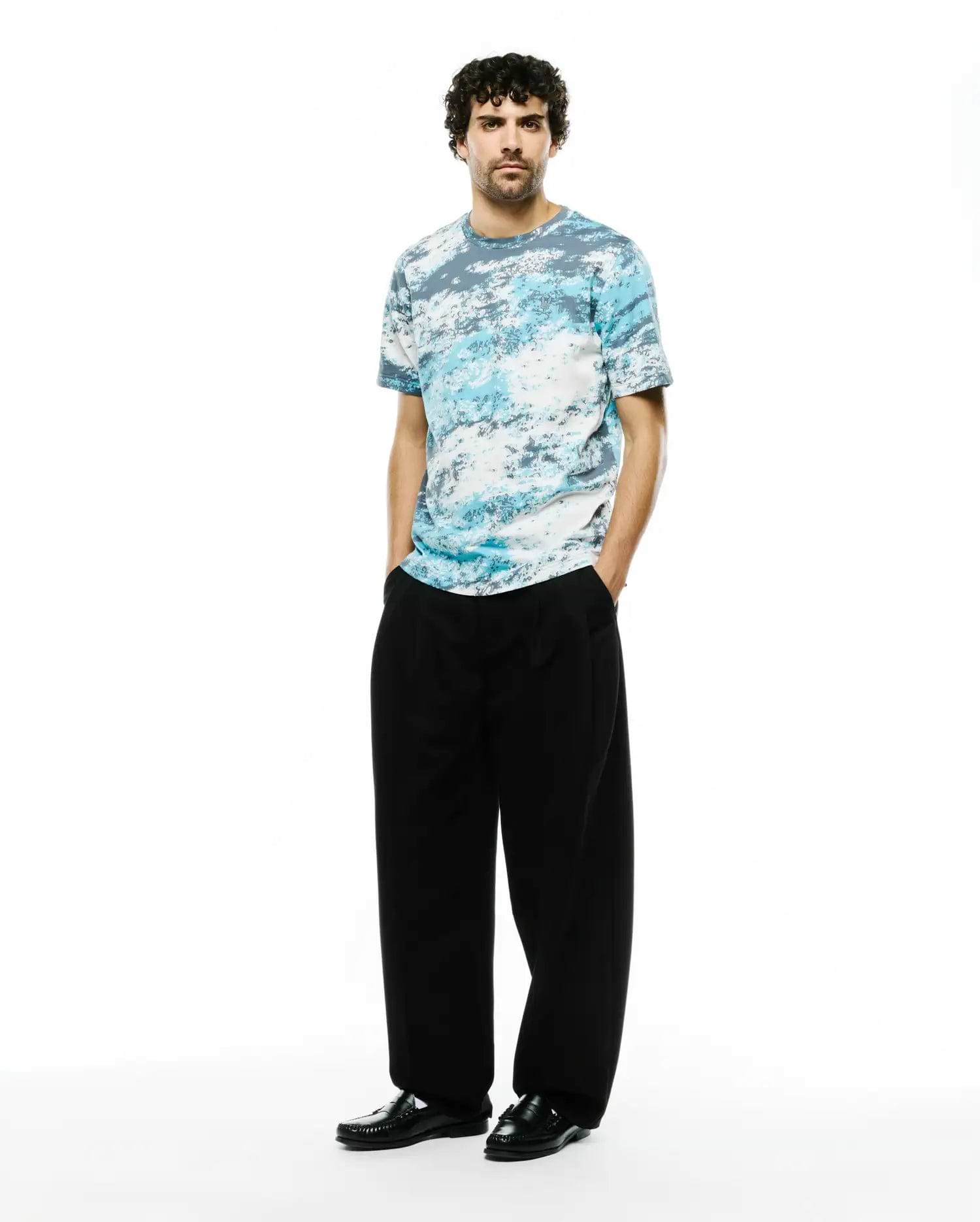 Psycho Bunny Men's Alfie All-Over Jacquard Tee, a premium relaxed fit t-shirt with a soft jersey texture and an abstract blue, white, and grey cloud-like pattern. (4)