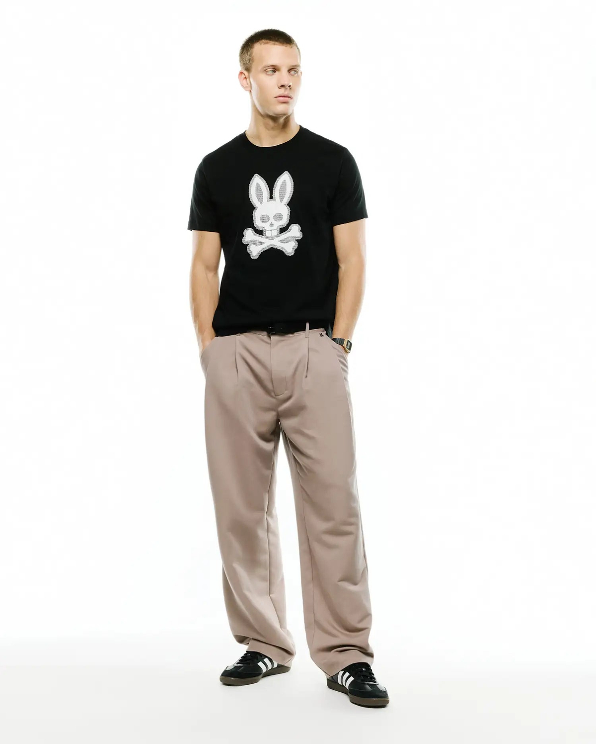 Men's Samson Graphic Tee, a classic fit black jersey t-shirt featuring a large, textured white Psycho Bunny skull and crossbones graphic prominently centered on the chest. (5)