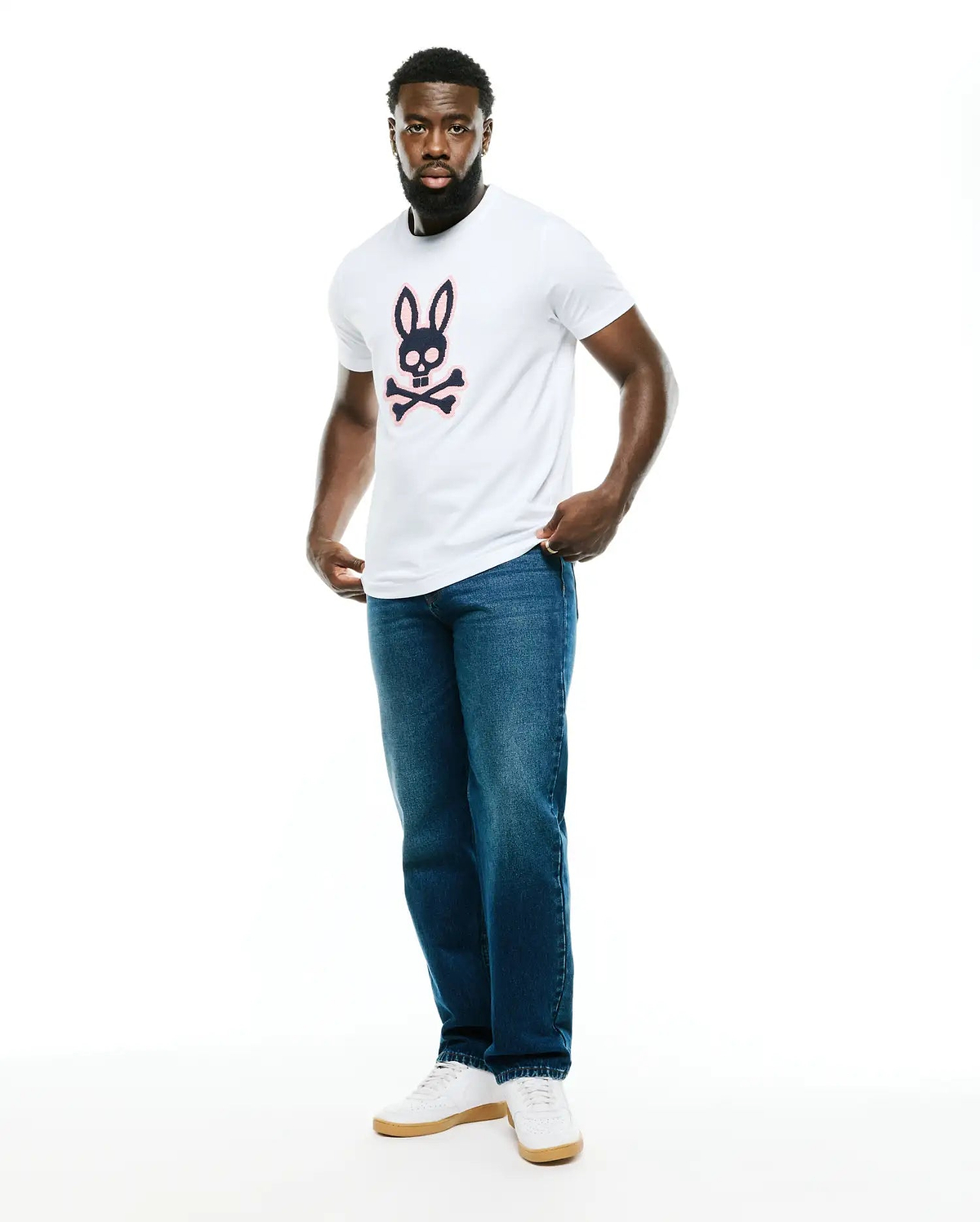 Men's Samson Graphic Tee, a classic fit white jersey t-shirt featuring a large navy and pink Psycho Bunny skull and crossbones graphic on the chest. (5)