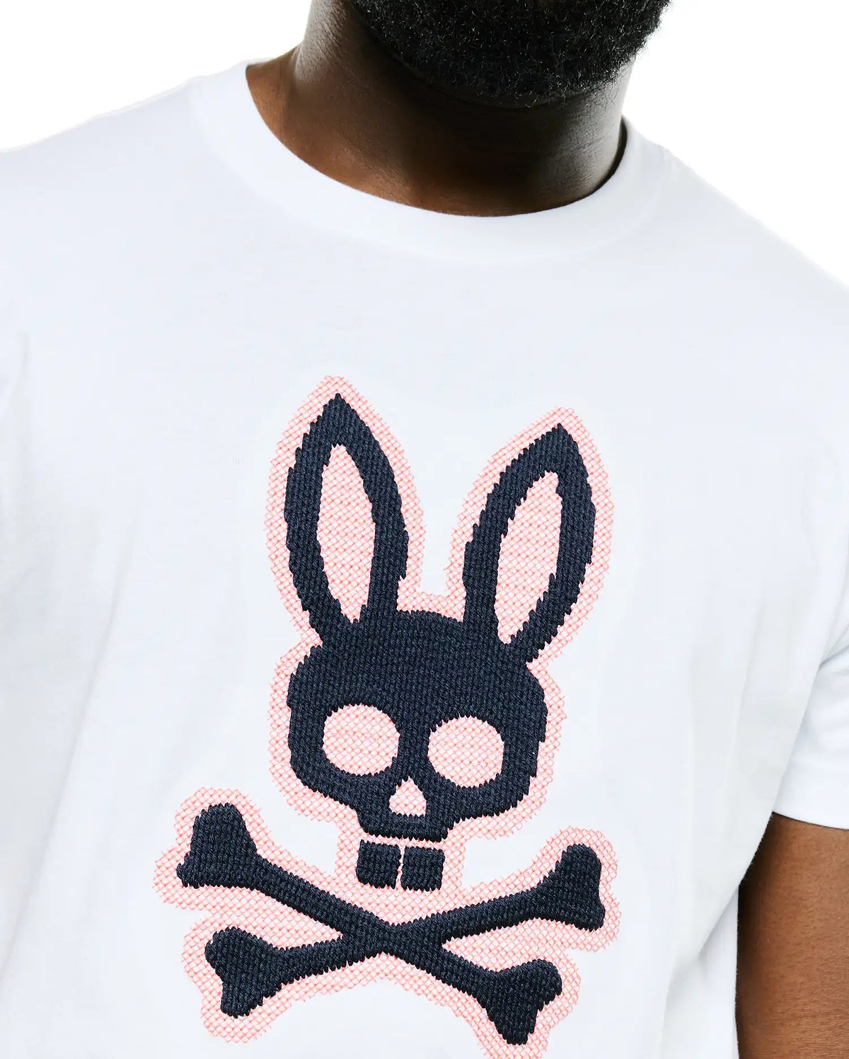 White Men's Samson Graphic Tee, classic fit, featuring a large black and pink cross-stitch Psycho Bunny skull logo on the chest, made from smooth jersey fabric. (3)
