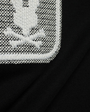 Men's Samson Wordmark Graphic Tee in black, crafted from soft jersey knit. Features a large, textured white embroidered Psycho Bunny skull logo on a white mesh patch. (6)