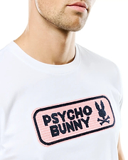 Men's Samson Wordmark Graphic Tee, white classic fit jersey t-shirt with a large central chest embroidered pink patch featuring the black Psycho Bunny wordmark and iconic bunny skull logo. (3)