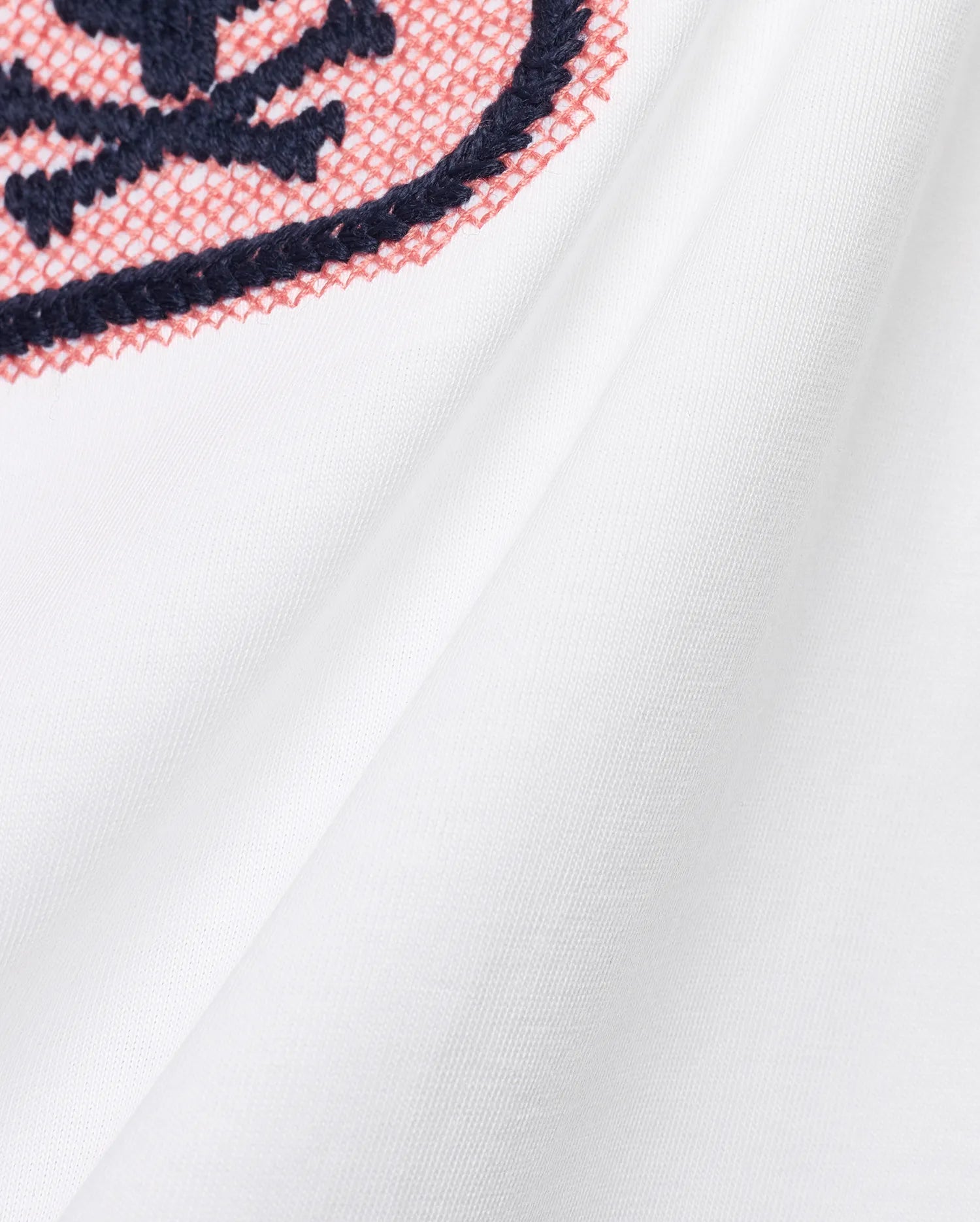 Men's Samson Wordmark Graphic Tee in white, featuring a prominent embroidered graphic with navy outline and coral cross-stitch fill on soft jersey fabric. (6)