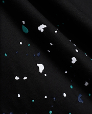 Black Mens Malcolm Graphic Tee crafted from smooth jersey knit fabric, adorned with an intricate embroidered paint splatter pattern in white, vibrant teal, and deep blue.