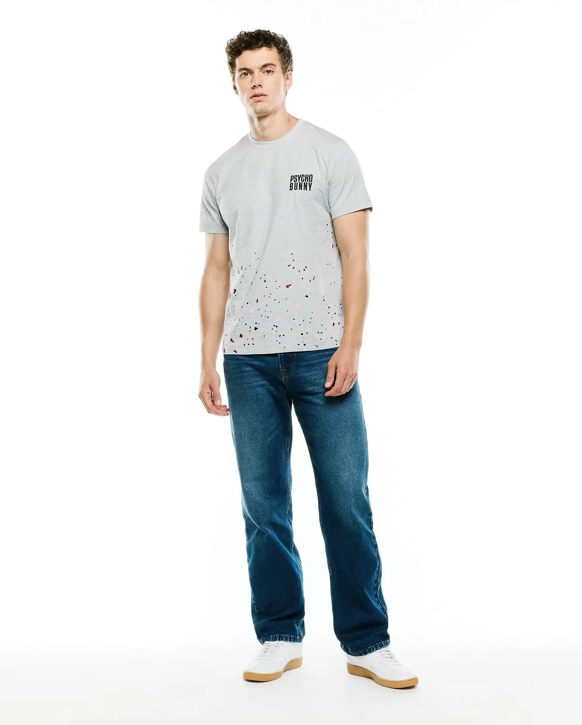 Mens Malcolm Graphic Tee, a classic fit heather grey jersey t-shirt featuring a small black Psycho Bunny text logo on the left chest and a vibrant paint splatter graphic in black, pink, and red across the lower front.