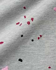 Mens Malcolm Graphic Tee, a heather grey jersey knit fabric detailed with embroidered red, black, and pink paint splatter graphics for a bold, refined streetwear look.