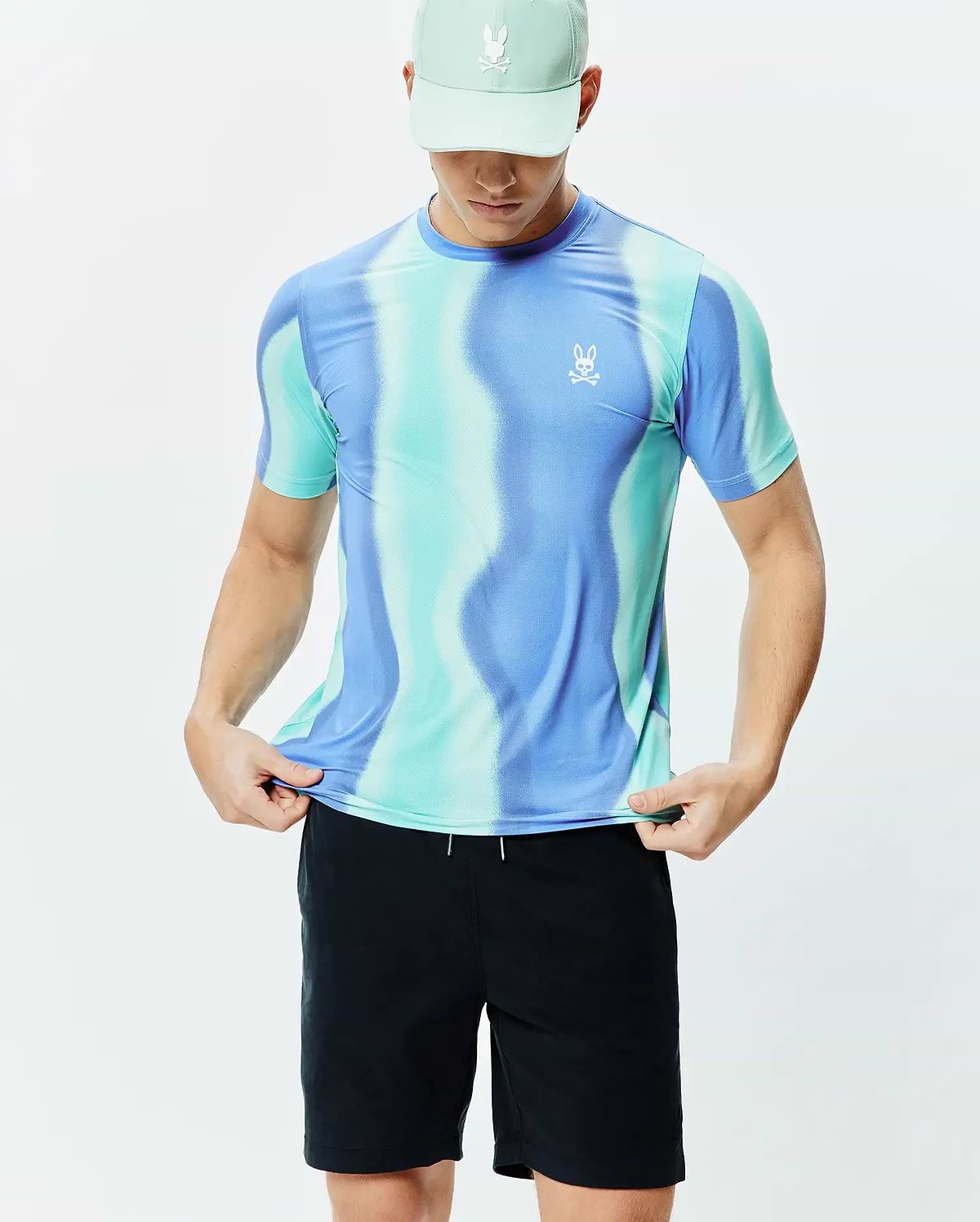 Mens Blaze Sport Tee in a vibrant blue and teal wavy gradient pattern, crafted from performance knit fabric with a classic fit and a small white Psycho Bunny logo on the left chest.