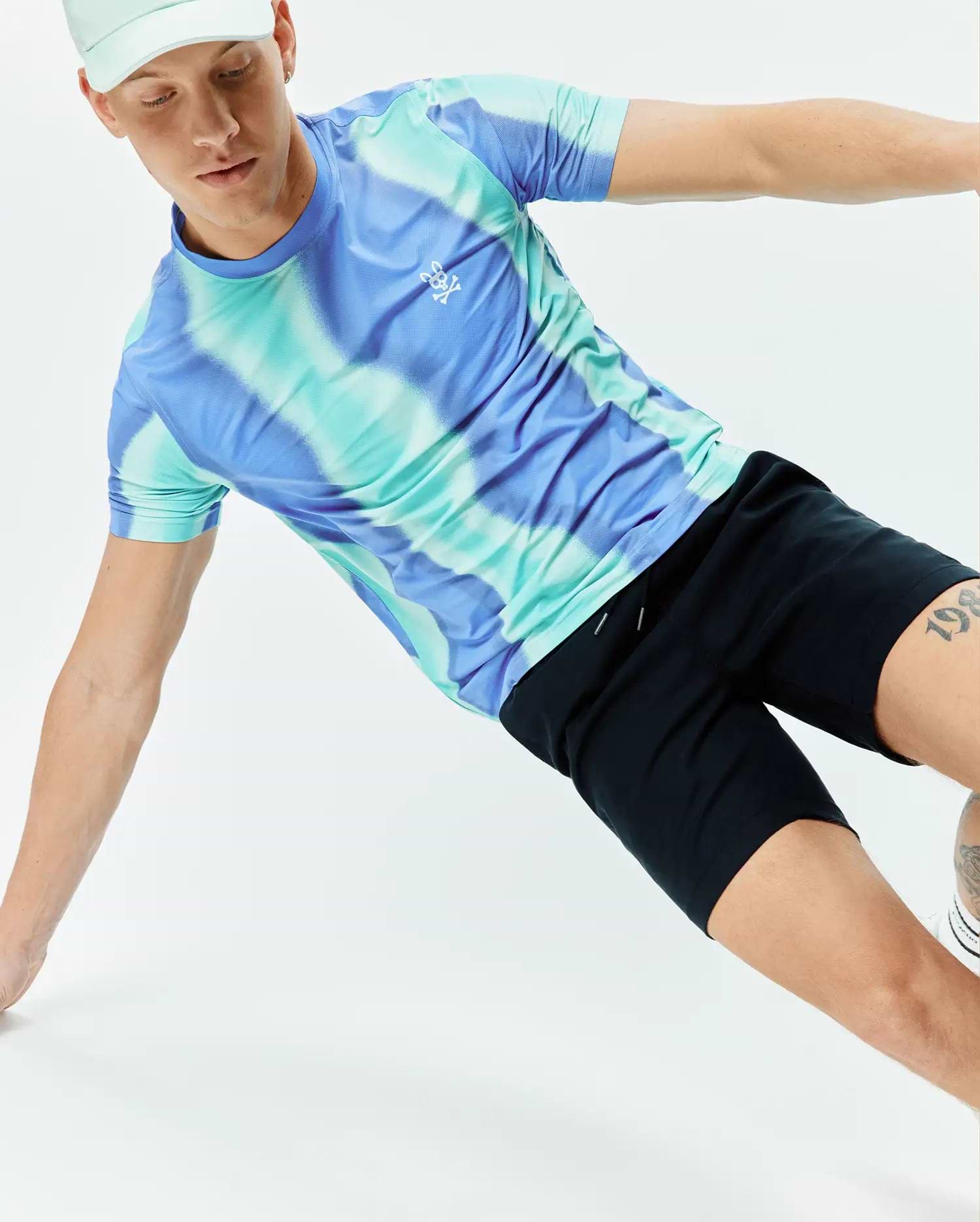Mens Blaze Sport Tee in a vibrant blue and teal tie-dye pattern, featuring a classic fit and smooth performance jersey fabric, with a small white Psycho Bunny skull logo on the left chest.