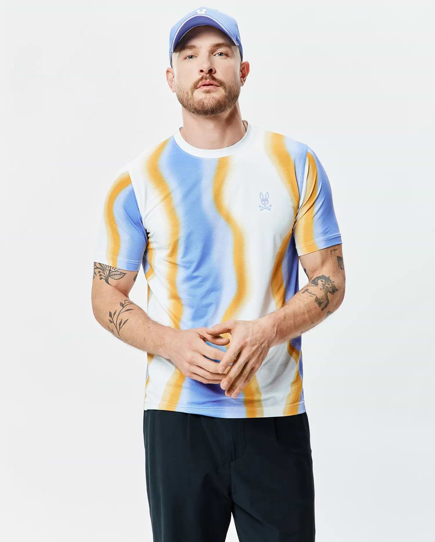 Mens Blaze Sport Tee, a slim fit performance jersey t-shirt featuring a vibrant white, blue, and orange swirling wave pattern with a small embroidered Psycho Bunny skull logo on the left chest.