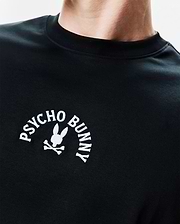 Mens Stevie Relaxed Fit Tee in black jersey knit, featuring a relaxed fit and a prominent white embroidered Psycho Bunny logo with the iconic bunny skull on the left chest.