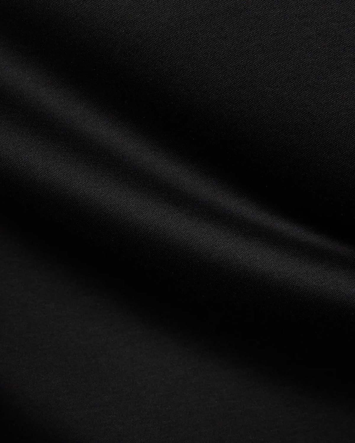 Psycho Bunny Mens Stevie Relaxed Fit Tee in deep black, made from smooth jersey fabric with subtle texture, featuring the iconic small embroidered bunny skull logo on the left chest.