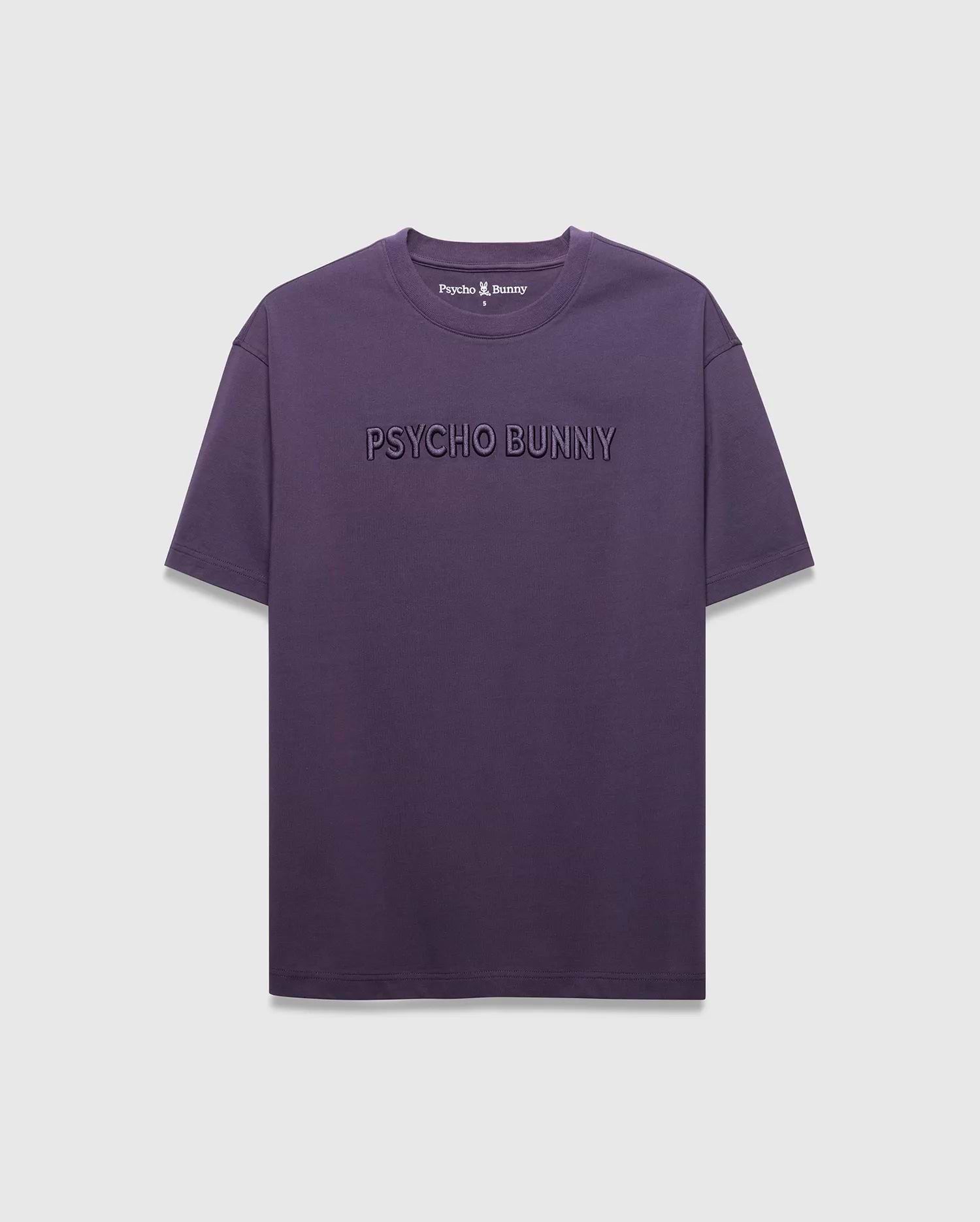 MENS WINDCREST RELAXED FIT TEE in deep plum jersey, featuring a large tonal embossed PSYCHO BUNNY text across the chest and a small embroidered bunny skull logo at the back neck.