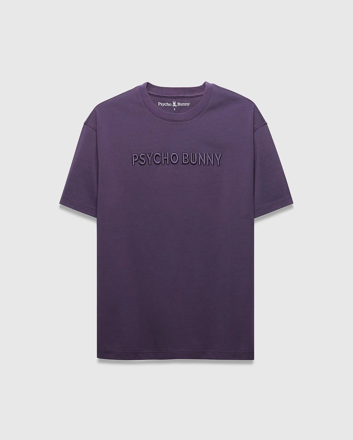 MENS WINDCREST RELAXED FIT TEE in deep plum jersey, featuring a large tonal embossed PSYCHO BUNNY text across the chest and a small embroidered bunny skull logo at the back neck.
