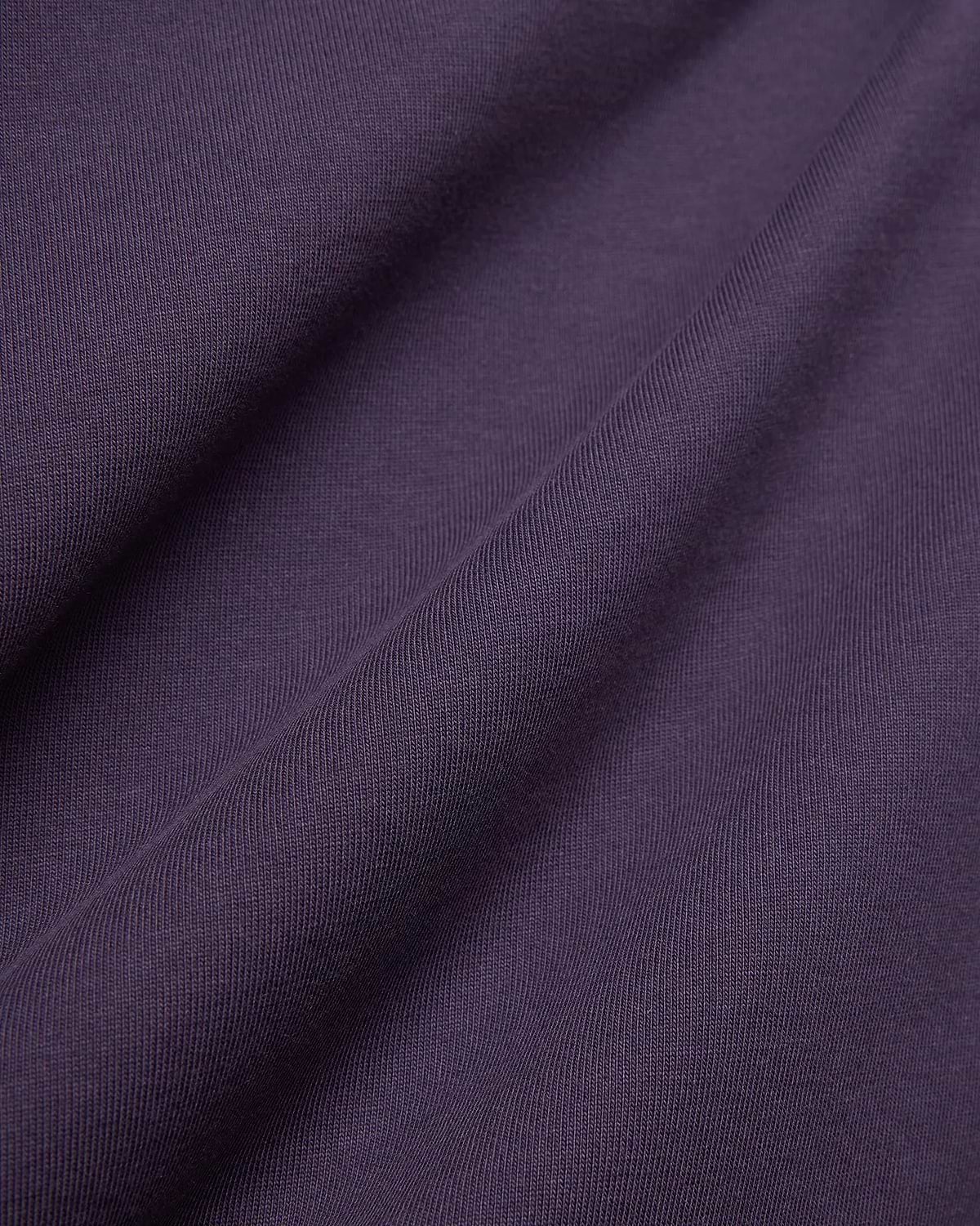 Dark Purple Mens Windcrest Relaxed Fit Tee fabric, featuring a soft, finely ribbed jersey knit texture with subtle vertical lines and gentle folds.