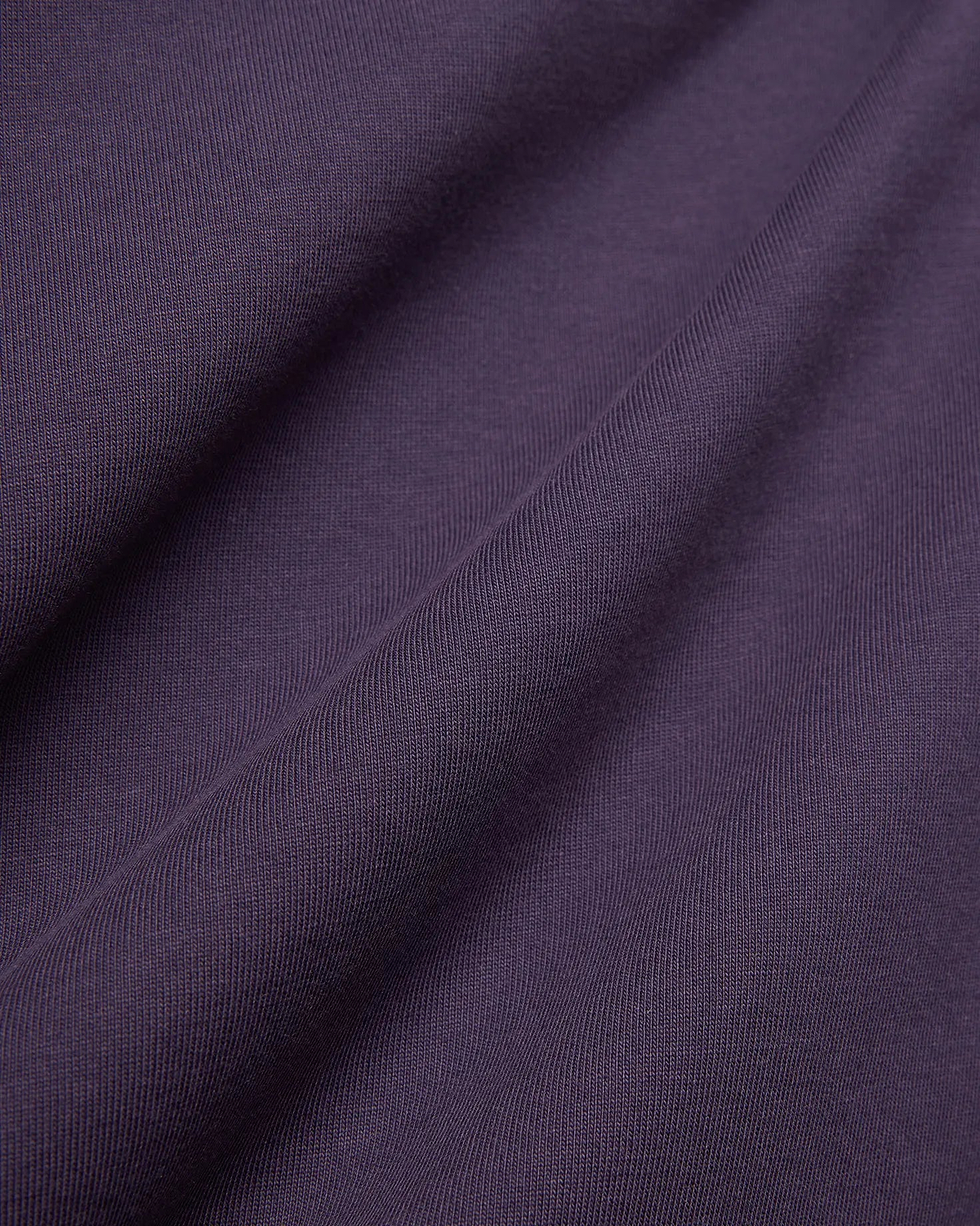 Dark Purple Mens Windcrest Relaxed Fit Tee fabric, featuring a soft, finely ribbed jersey knit texture with subtle vertical lines and gentle folds.