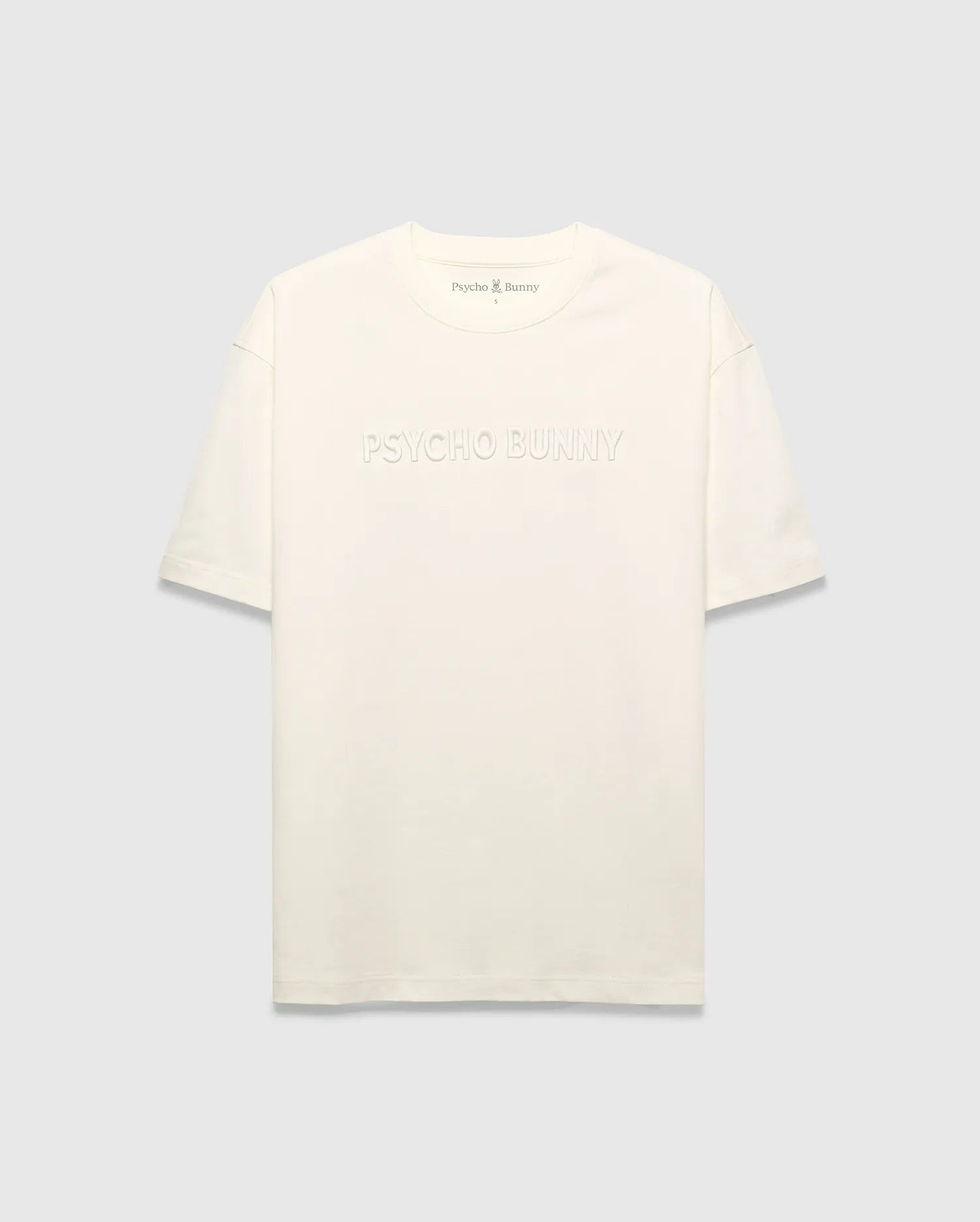 Mens Windcrest Relaxed Fit Tee in cream jersey, featuring a large tonal embossed PSYCHO BUNNY chest logo and a small embroidered bunny skull on the back neck. (5)