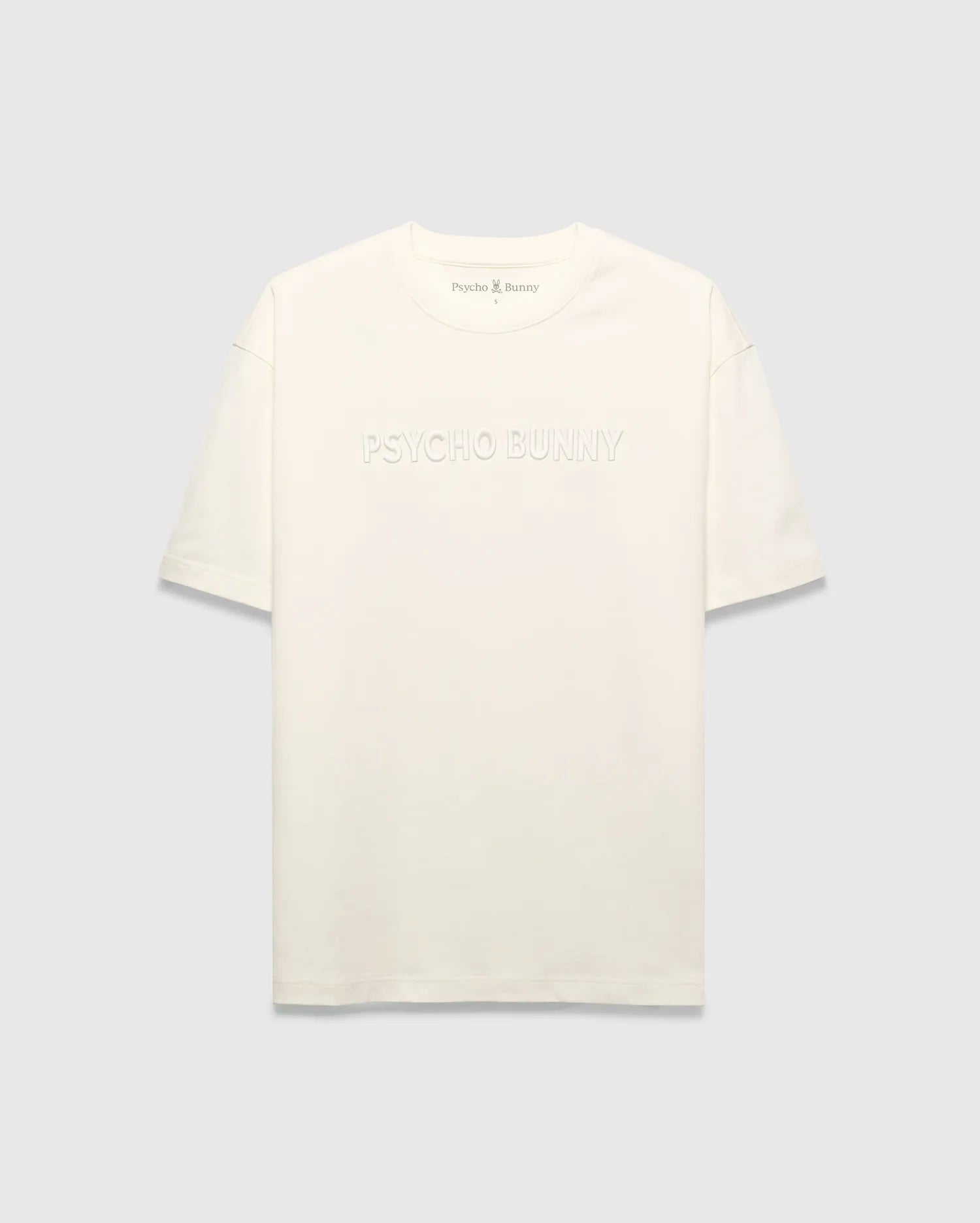 Mens Windcrest Relaxed Fit Tee in cream jersey, featuring a large tonal embossed PSYCHO BUNNY chest logo and a small embroidered bunny skull on the back neck. (5)