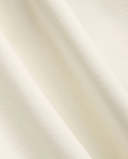Mens Windcrest Relaxed Fit Tee in a soft, creamy off-white hue, showcasing its premium, smooth fine jersey knit fabric texture with elegant, flowing diagonal folds. (6)