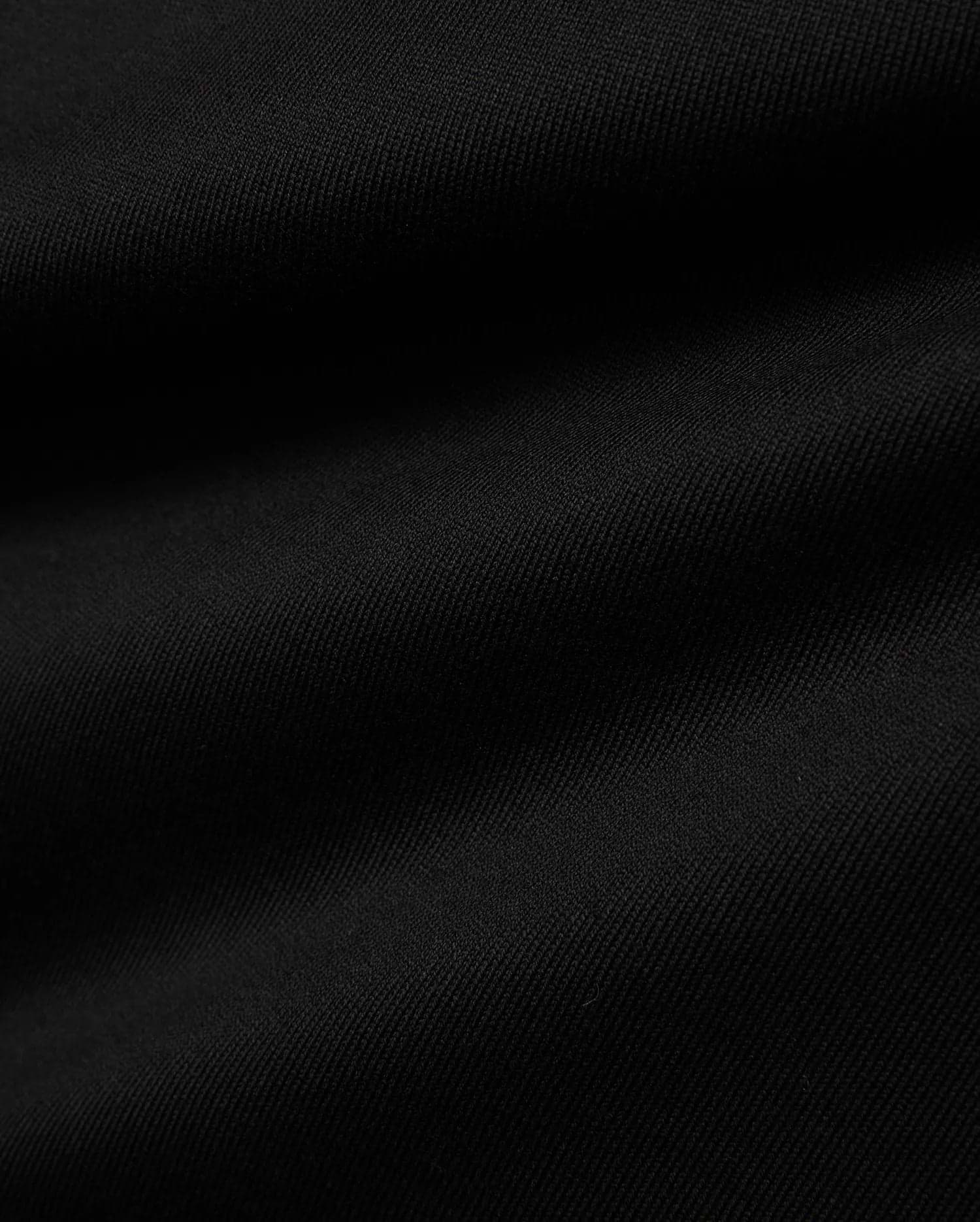 Men's Samson Oversized Bunny Tee, a black premium jersey knit fabric with a subtle diagonal texture, embodying Psycho Bunny's refined streetwear aesthetic. (6)