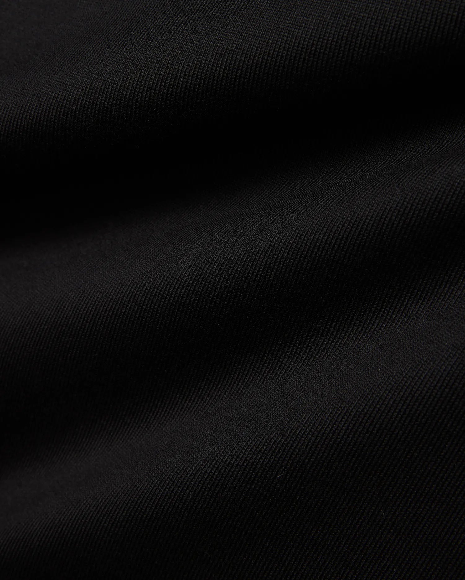 Men's Samson Oversized Bunny Tee, a black premium jersey knit fabric with a subtle diagonal texture, embodying Psycho Bunny's refined streetwear aesthetic. (6)