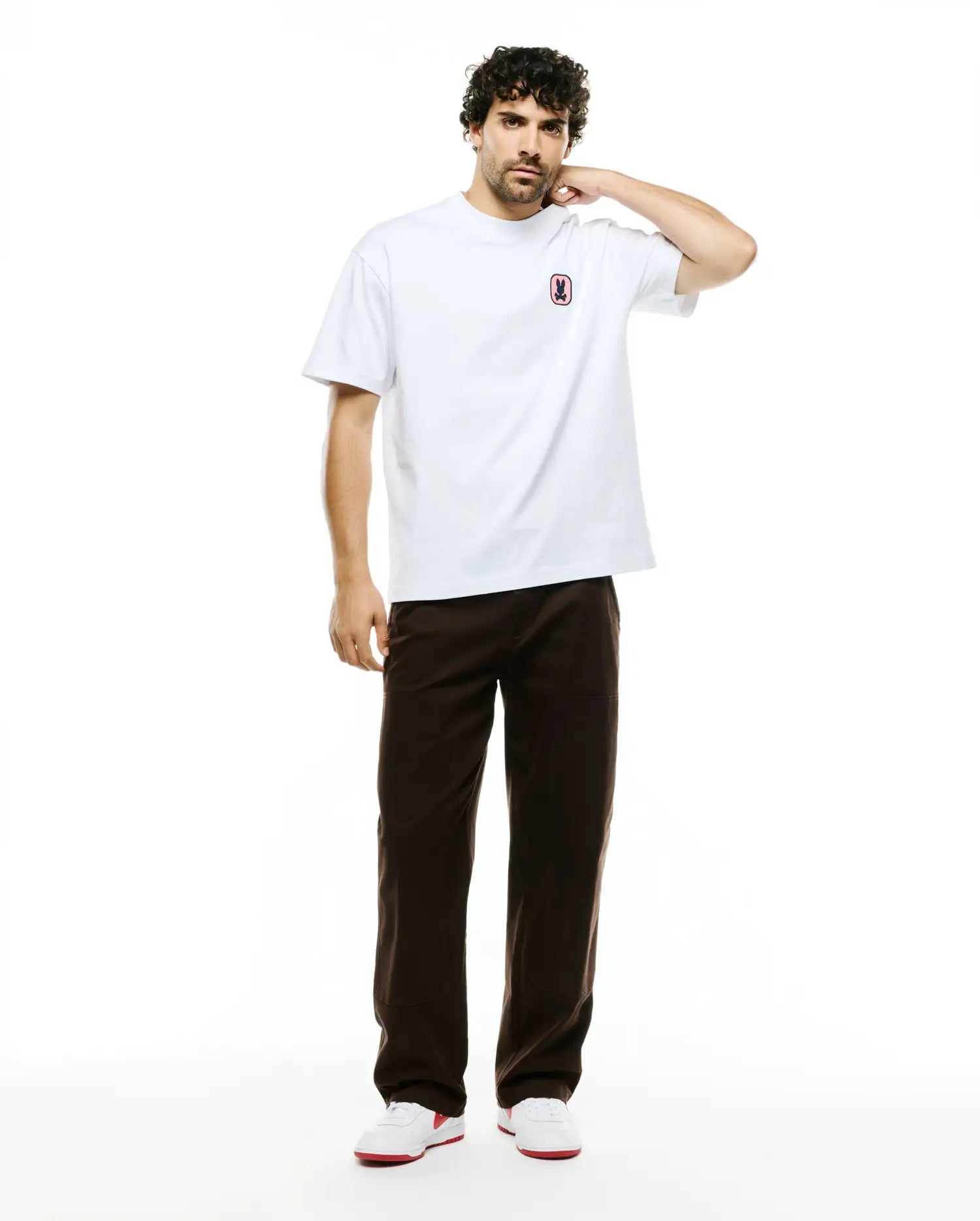 Men's Samson Oversized Bunny Tee, a white oversized smooth jersey t-shirt with a small, embroidered pink and black Psycho Bunny skull logo on the left chest. (4)