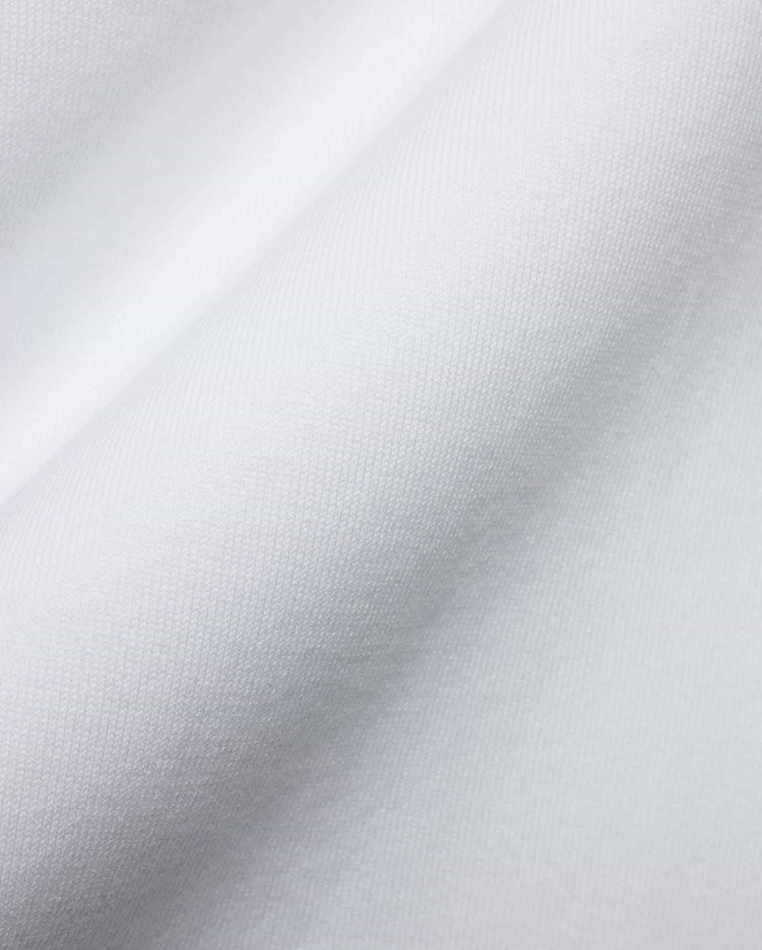 Men's Samson Oversized Bunny Tee, crafted from luxurious white jersey knit fabric with a fine, soft texture and subtle draping, reflecting Psycho Bunny's premium streetwear style and iconic bunny skull branding. (6)