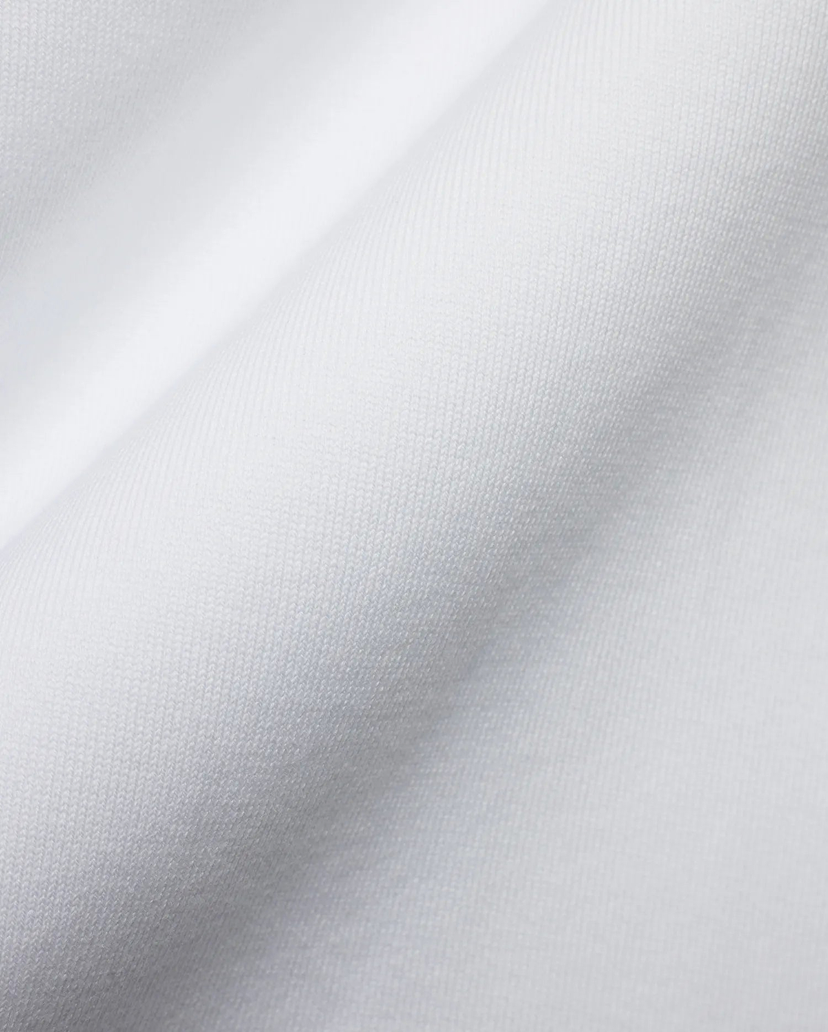 Men's Samson Oversized Bunny Tee, crafted from luxurious white jersey knit fabric with a fine, soft texture and subtle draping, reflecting Psycho Bunny's premium streetwear style and iconic bunny skull branding. (6)