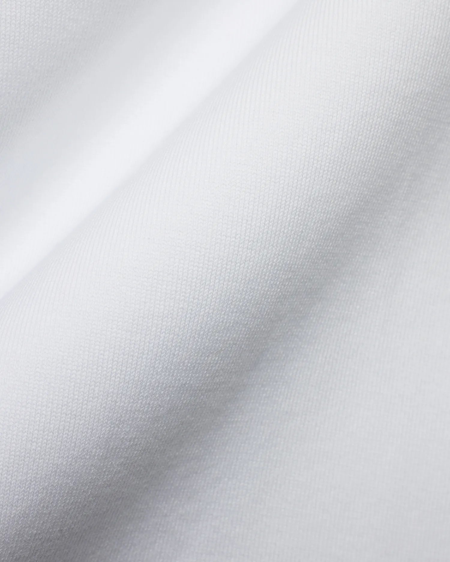 Men's Samson Oversized Bunny Tee, crafted from luxurious white jersey knit fabric with a fine, soft texture and subtle draping, reflecting Psycho Bunny's premium streetwear style and iconic bunny skull branding. (6)