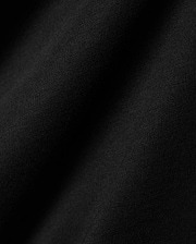 Black Mens Dariel Long Sleeve Back Graphic Tee, crafted from premium, soft jersey knit fabric with subtle vertical texture and elegant folds, reflecting refined streetwear quality.