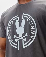 Mens Santa Fe Bunny Graphic Tee, a dark grey classic fit jersey t-shirt featuring a large white Psycho Bunny skull and crossbones logo with circular text on the chest. (3)