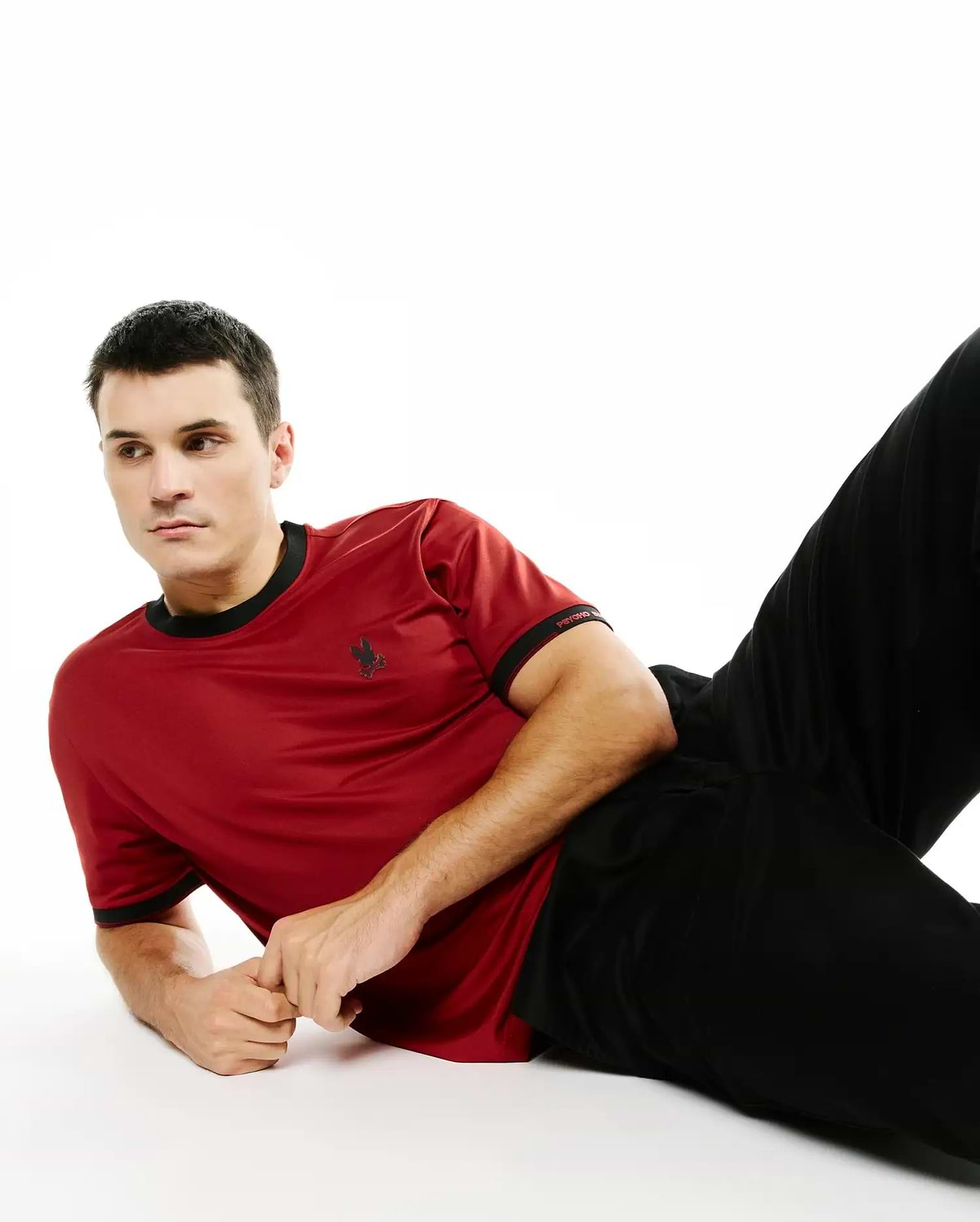 Men's Edmonds Chest Bunny Sport Tee, a classic fit deep red jersey knit t-shirt with black ribbed collar and cuffs, featuring a small black embroidered bunny skull on the left chest and Psycho Bunny text on the right sleeve. (3)