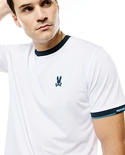 Men's Edmonds Chest Bunny Sport Tee, white performance jersey with navy ringer collar and sleeve cuffs, light blue stripes, embroidered chest bunny skull logo, and PSYCHO BUNNY text on cuff. (3)