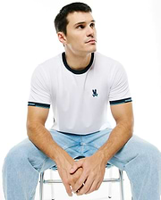 Men's Edmonds Chest Bunny Sport Tee: White jersey t-shirt with a dark blue ringer collar, banded sleeves featuring light blue stripes and Psycho Bunny text, and an embroidered teal bunny skull logo on the chest. (1)