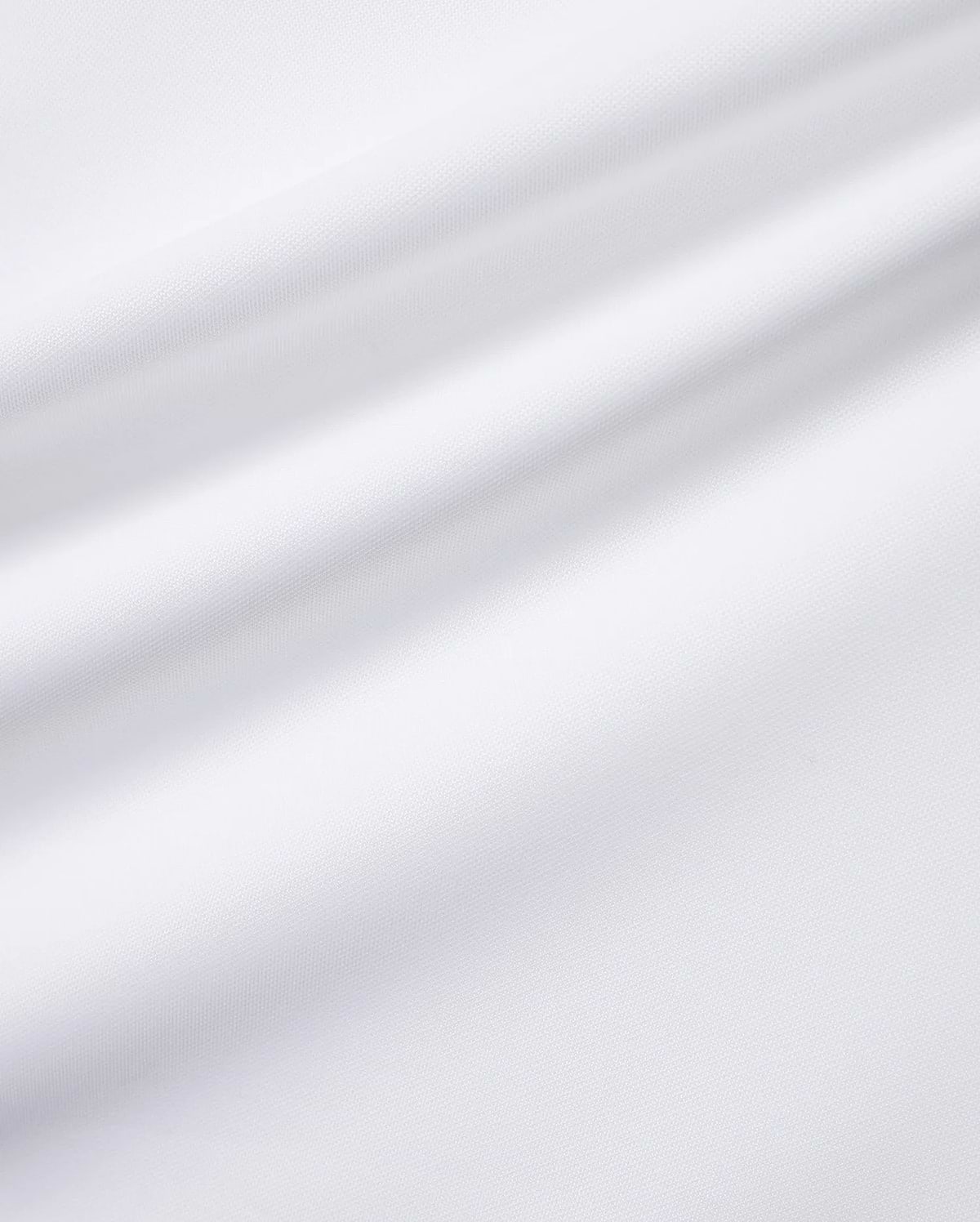 Close-up of the white Men's Edmonds Chest Bunny Sport Tee, showcasing its premium, subtly textured performance jersey fabric, with an implied small embroidered Psycho Bunny skull logo. (6)