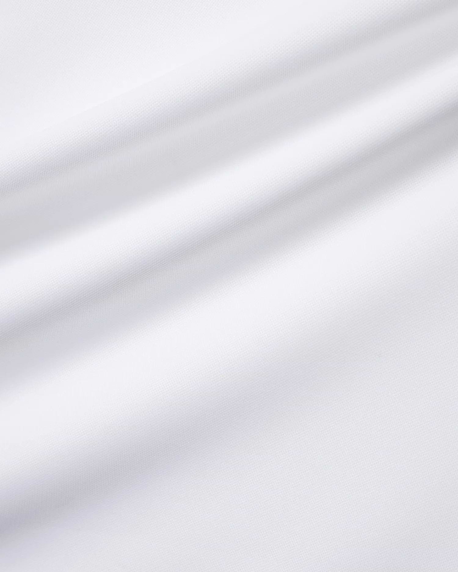 Close-up of the white Men's Edmonds Chest Bunny Sport Tee, showcasing its premium, subtly textured performance jersey fabric, with an implied small embroidered Psycho Bunny skull logo. (6)