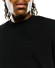 Mens Arlen Relaxed Seersucker Tee, black, featuring a textured seersucker fabric and a small, tonal embroidered Psycho Bunny skull logo on the left chest.