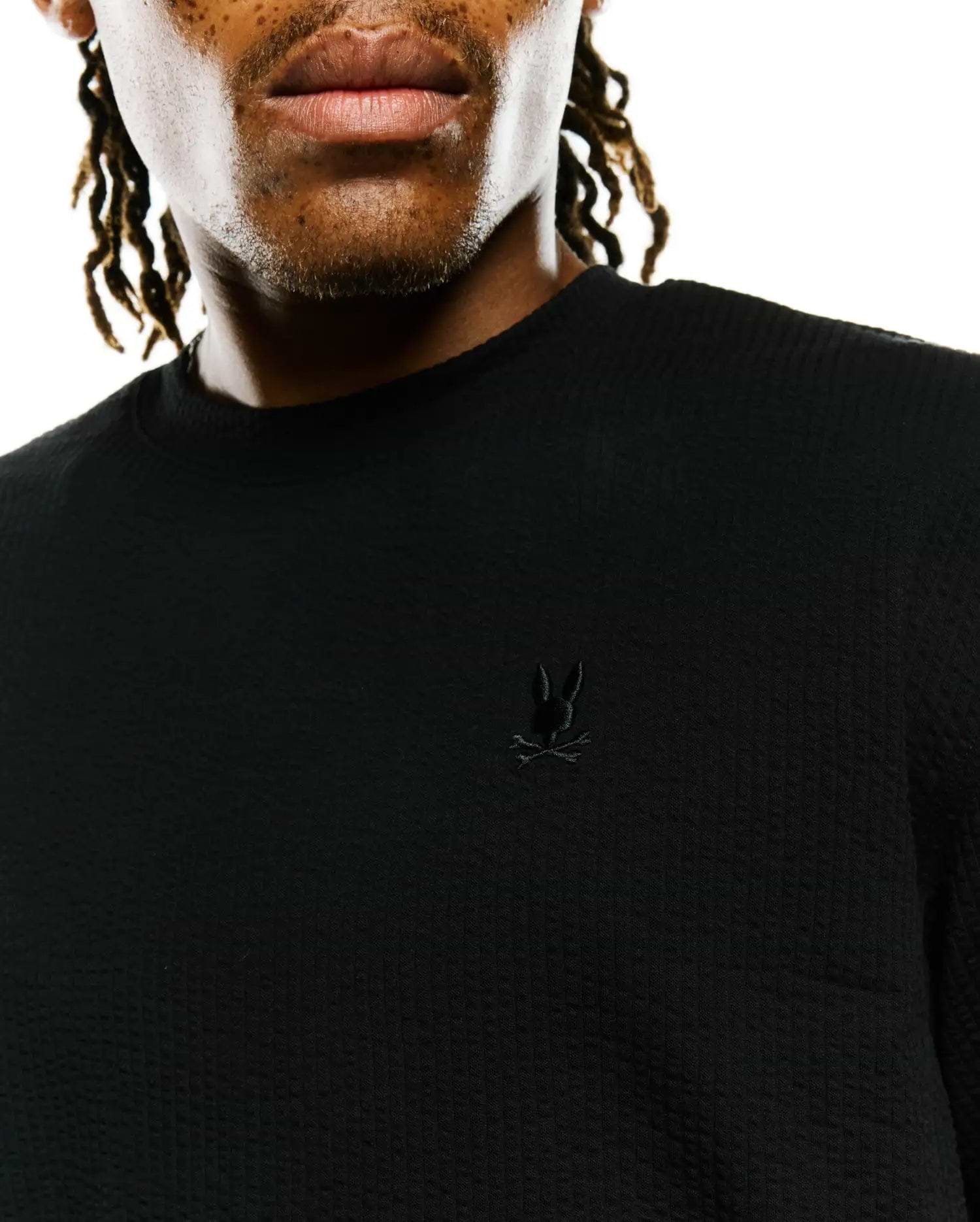 Mens Arlen Relaxed Seersucker Tee, black, featuring a textured seersucker fabric and a small, tonal embroidered Psycho Bunny skull logo on the left chest.
