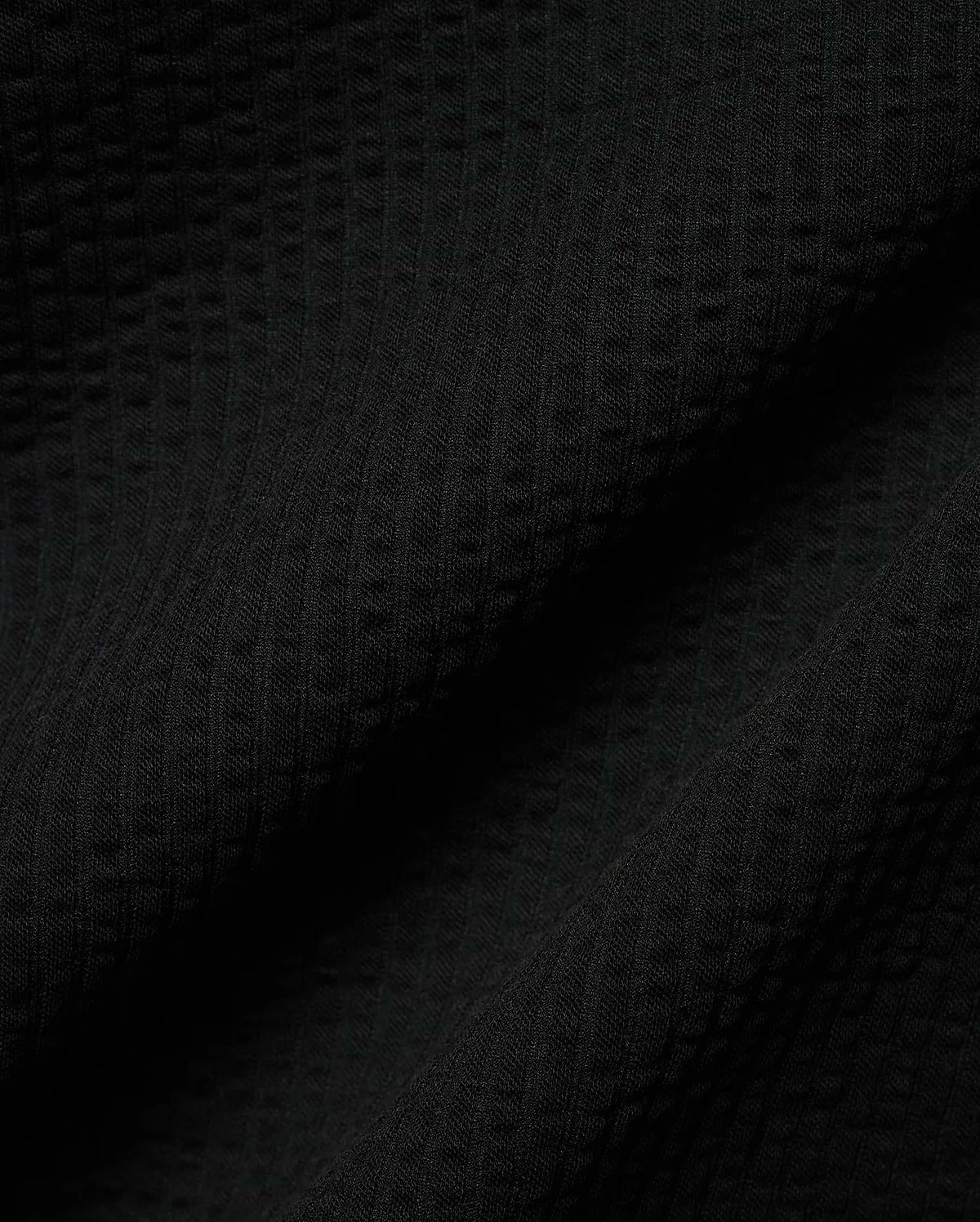 Mens Arlen Relaxed Seersucker Tee, a premium black tee crafted from a distinctive puckered seersucker fabric, offering a relaxed fit and refined streetwear aesthetic.