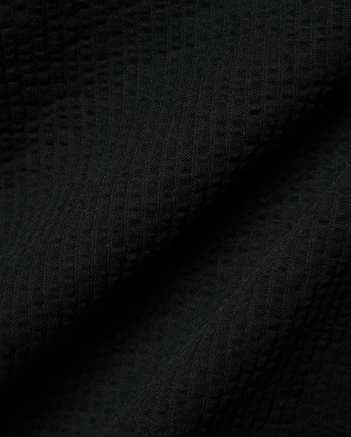 Mens Arlen Relaxed Seersucker Tee, a premium black tee crafted from a distinctive puckered seersucker fabric, offering a relaxed fit and refined streetwear aesthetic.