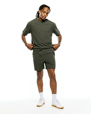 Mens Arlen Relaxed Seersucker Tee in olive green, featuring a textured seersucker fabric and a small embroidered Psycho Bunny skull logo on the left chest, paired with matching seersucker shorts.