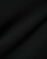 Black Makai Textured Knit T-Shirt, a premium streetwear garment featuring a distinct, small-scale horizontal textured knit pattern, reflecting Psycho Bunny's refined aesthetic.